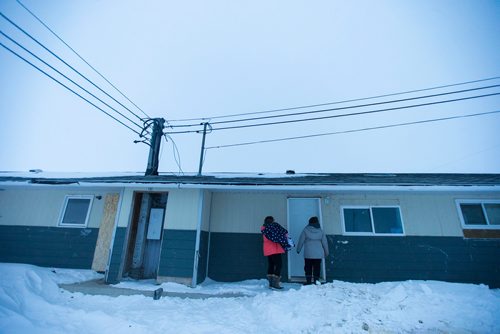 MIKAELA MACKENZIE / WINNIPEG FREE PRESS
Manitoba Underdogs volunteers Jessica Hansen (left) and Mychal Nemetchuk drop off puppy food to a community member on the Chemawawin First Nation Reserve, Manitoba on Saturday, Feb. 24, 2018. Many Northern Manitoban communities have problems with stray dog overpopulation, and initiatives like these aim to reduce their numbers in a humane way while increasing the quality of life for dogs and humans.
180224 - Saturday, February 24, 2018.