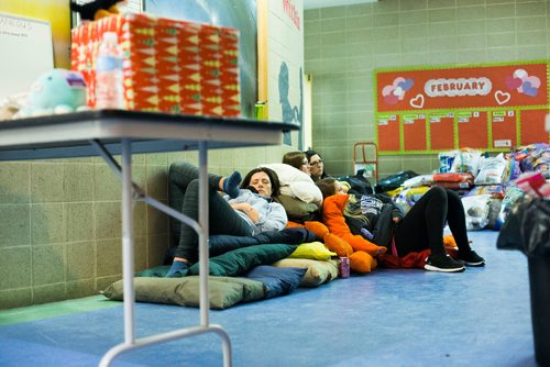 MIKAELA MACKENZIE / WINNIPEG FREE PRESS
Manitoba Underdogs volunteers take a rest near the end of a busy day on dog beds ready to go out to community members at a dog spay and neuter clinic on the Chemawawin First Nation Reserve, Manitoba on Saturday, Feb. 24, 2018. Many Northern Manitoban communities have problems with stray dog overpopulation, and initiatives like these aim to reduce their numbers in a humane way while increasing the quality of life for dogs and humans.
180224 - Saturday, February 24, 2018.