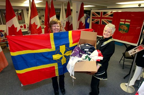 BORIS MINKEVICH / WINNIPEG FREE PRESS
Argyle Museum Settlers, Rails & Trails Inc flag museum in the Argyle Community Centre. From left, Carol Morgan and Joan Grandmont with some flags donated . BILL REDEKOP STORY Feb. 28, 2018