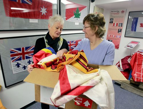 BORIS MINKEVICH / WINNIPEG FREE PRESS
Argyle Museum Settlers, Rails & Trails Inc flag museum in the Argyle Community Centre. From left, Joan Grandmont and Carol Morgan with some flags donated . BILL REDEKOP STORY Feb. 28, 2018