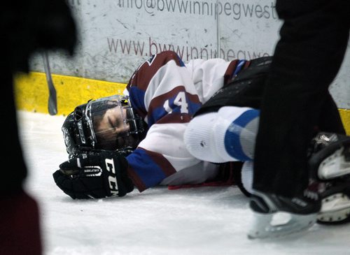 PHIL HOSSACK / WINNIPEG FREE PRESS -After a hit by St Paul Crusader #9 Michael O'Shea, Sturgeon Heights Huskie #14 Cayden Onagi lays unconscious before being taken hospital. See Mike Sawatzky's story.   - February 28, 2018
