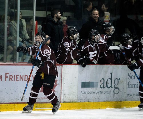 PHIL HOSSACK / WINNIPEG FREE PRESS -St Paul Crusader # 18 Matthew Sachvie celebrates scoring the fifth and final goal against the Sturgeon Heights Huskies shortly after he scored the 4th goal in the 3rd period of a hard hitting High School playoff game Wednesday. The game was called due to injury with the score 5-0 in favor of St Pauls Crusaders. See Mike Sawatzky's story.   - February 28, 2018