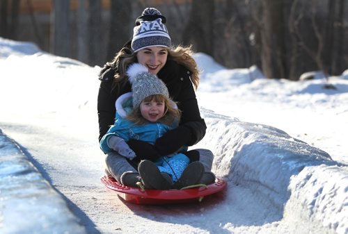 RUTH BONNEVILLE / WINNIPEG FREE PRESS

Blaire Ayotte races down the toboggan slide at St.Vital Park with her niece Ruby Hrycyna (3yrs) in the balmy winter weather this week.
Standup photo taken on Wednesday. 
March 01,18