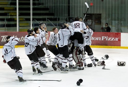 PHIL HOSSACK / WINNIPEG FREE PRESS - St Paul's Crusaders pile up celebrating their 6-2 point victory over the Sturgeon Heights Huskies Thursday evening as the two teams played out the last game of a WHSHL final.  See Mike Sawatzky's story.   - March 1, 2018