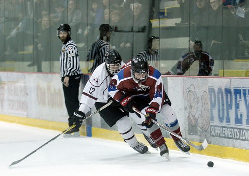 PHIL HOSSACK / WINNIPEG FREE PRESS - St Paul's Crusaders #12 Michael Lee hot on the heels of Sturgeon Heights Huskie #9 Matthew Mason-Vandel Thursday evening as the two teams played out the last game of a WHSHL final.  See Mike Sawatzky's story.   - March 1, 2018