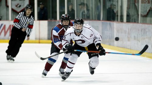 PHIL HOSSACK / WINNIPEG FREE PRESS - Sturgeon Heights Huskies # 21 Zachary Greenwood pursues St Paul's Crusaders #18 Matthew Sachvie Thursday evening as the two teams played out the last game of a WHSHL final.  See Mike Sawatzky's story.   - March 1, 2018
