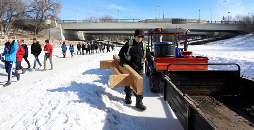 RUTH BONNEVILLE / WINNIPEG FREE PRESS

The Forks River Trail staff load up benches along the River Trail on the Assiniboine River as students walk on pathway for the last time of the season Friday.  

March 01,18