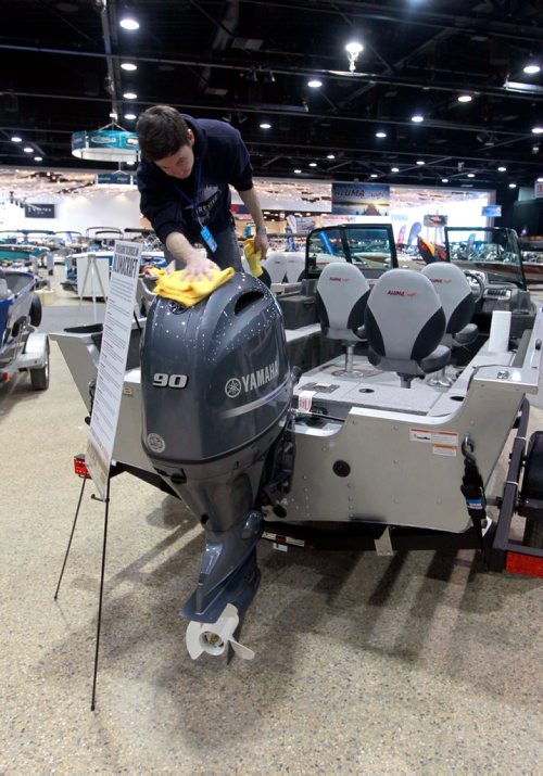 BORIS MINKEVICH / WINNIPEG FREE PRESS
The Mid-Canada Boat Show (also referred to as the Winnipeg Boat Show) started yesterday and goes on through the weekend at the RBC Convention Centre. Guertin Equipment worker Brennan Tait wipes the fingerprints off of a boat motor in their display area. March 2, 2018