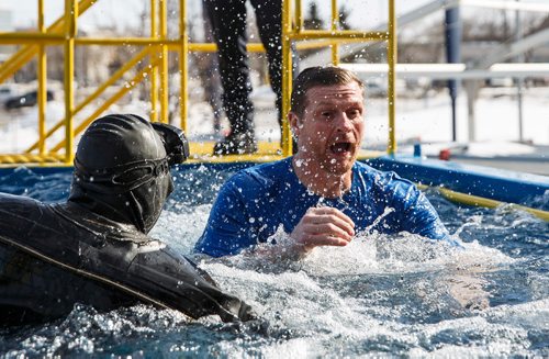 MIKE DEAL / WINNIPEG FREE PRESS
Winnipeg Blue Bombers head coach Mike O'Shea jumps into the tank to raise money for Special Olympics Manitoba. Participants jump into the deep end of a specially made tank at Investors Group Stadium Saturday afternoon in an event organized by the Law Enforcement Torch Run which raised more than $25,000 last year.
180303 - Saturday, March 03, 2018.