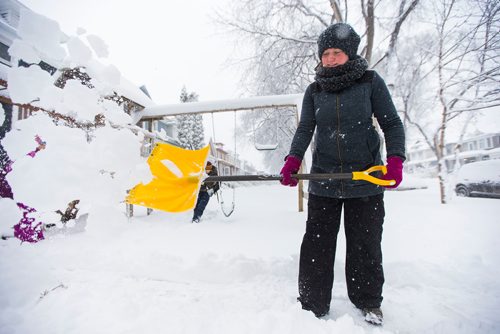 MIKAELA MACKENZIE / WINNIPEG FREE PRESS
Jennifer Forster shovels snow after a big storm in Winnipeg, Manitoba on Monday, March 5, 2018.
180305 - Monday, March 05, 2018.