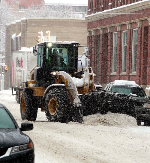 BORIS MINKEVICH / WINNIPEG FREE PRESS
Winter storm grips Winnipeg today. A snow plow fights the battle in the Exchange District on McDermot Avenue near Arthur Street. March 5, 2018