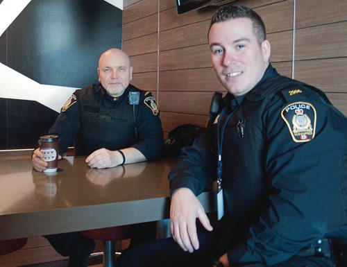 Canstar Community News Consts. Vern Novalkowski (left) and Shawn Smith of the Winnipeg Police Service met with the public at a Coffee with a Cop event at the McDonald's at 1460 Henderson Hwy. on Feb. 27.  (SHELDON BIRNIE/CANSTAR/THE HERALD)