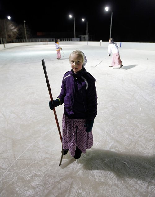 PHIL HOSSACK / WINNIPEG FREE PRESS - Chloe Maendel 8yrs, stops to gaze back at the photographer on the Baker Colony ice rink. -See Melissa Martin's story.  - February 23, 2018