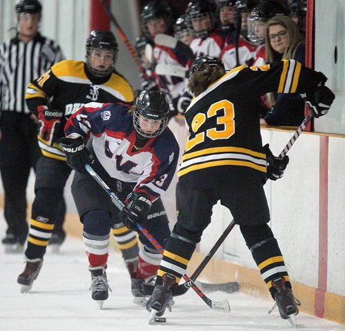 PHIL HOSSACK / WINNIPEG FREE PRESS -  St Marys Acadamy #13 Brooke Oxenforthe looks for the puck in the feet of Dakota Lancer #23 Rachel Bridle in playoff action at the Dakota Community Centre Wednesday afternoon. - March 7, 2018