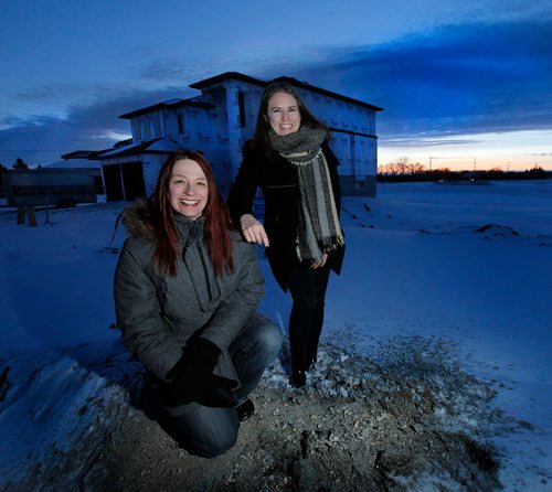 PHIL HOSSACK / WINNIPEG FREE PRESS -  Forester Patricia Pohrebniuk (left/lower) and realtor Carly Kuppers pose Wednesday. They are partnering up in a program that will see realtors buy tree plantings based on the size of a house sold. The house behind them would have the realtor paying to plant 50 trees. Kevin Rollason story. - March 7, 2018