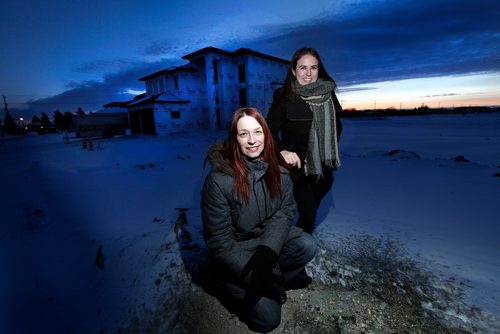 PHIL HOSSACK / WINNIPEG FREE PRESS -  Forester Patricia Pohrebniuk (left/lower) and realtor Carly Kuppers pose Wednesday. They are partnering up in a program that will see realtors buy tree plantings based on the size of a house sold. The house behind them would have the realtor paying to plant 50 trees. Kevin Rollason story. - March 7, 2018