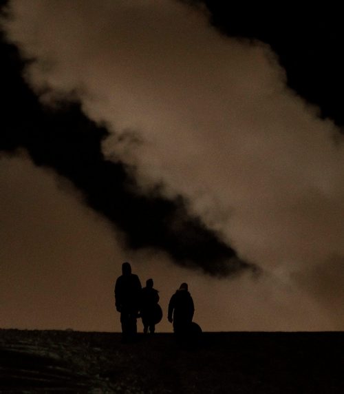 PHIL HOSSACK / WINNIPEG FREE PRESS -  A trio of tobogganers are  silhouetted against the sky Wednesday evening as they take advantage of the fresh snowfall at Westview Park. Standup.  - March 7, 2018
