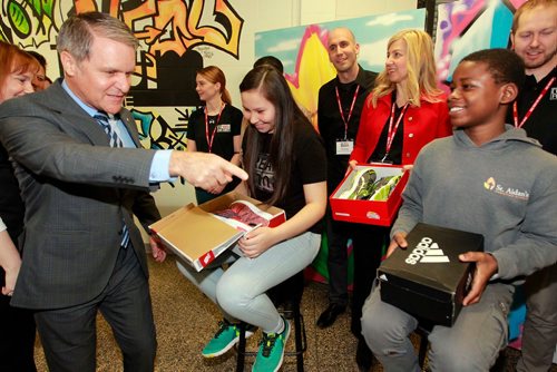 BORIS MINKEVICH / WINNIPEG FREE PRESS
From left, Finance Minister Cameron Friesen gives some new shoes to Phoenix cook, 14, and Gervas Kezimana, 14, at the YFC Activity Centre, 333 King St. This is a unique-to-Manitoba version of the new shoes on budget day tradition for Canadian finance ministers. NICK MARTIN STORY. March , 2018