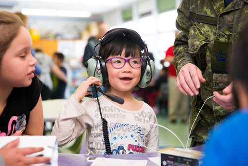 MIKAELA MACKENZIE / WINNIPEG FREE PRESS
Jessie Chen, six, tries on headphones at an activity where women in various fields of work came in and talked to children on Women's Day at Weston School in Winnipeg, Manitoba on Thursday, March 8, 2018.
180308 - Thursday, March 08, 2018.