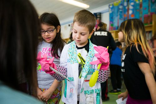 MIKAELA MACKENZIE / WINNIPEG FREE PRESS
Wyatt Kind, six, gets his instruments ready before beginning a pretend "surgery" with Dr. Nafisa Dharamsi at an activity where women in various fields of work came in and talked to children on Women's Day at Weston School in Winnipeg, Manitoba on Thursday, March 8, 2018.
180308 - Thursday, March 08, 2018.