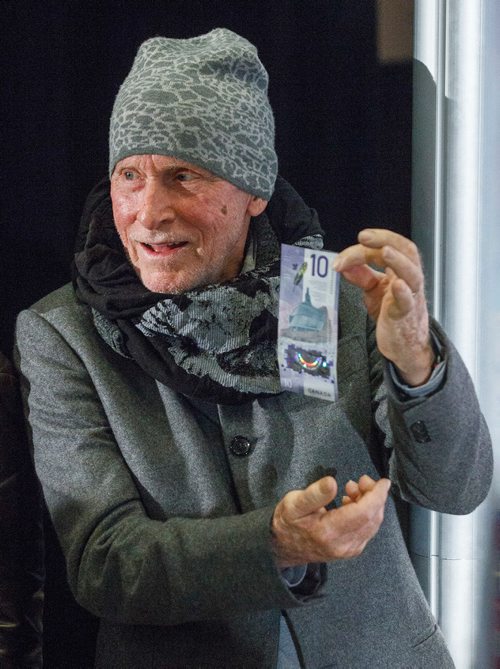 MIKE DEAL / WINNIPEG FREE PRESS
The architect of the CMHR building, Antoine Predock, checks out the new $10 bill.
At a simultaneous ceremony held at the Canadian Museum for Human Rights in Winnipeg and the Halifax Central Library in Nova Scotia, Canada's new $10 banknote, featuring a portrait of human rights defender Viola Desmond on the front and the CMHR on the back, was unveiled. 
180308 - Thursday, March 08, 2018.
