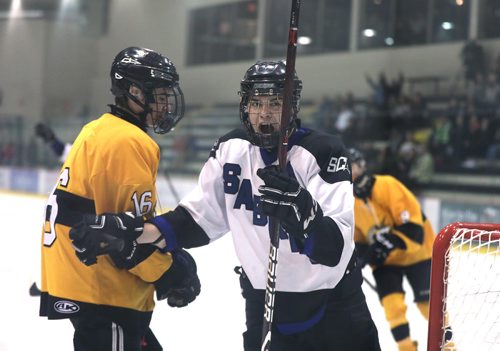 RUTH BONNEVILLE / WINNIPEG FREE PRESS

Dryden Bound #15 forward with  Sanford  (white) celebrates his teams goal against Steinbach in game 2 in boys High School Hockey Championships at Iceplex Thursday.  Sanford wins the game 10 - 3.  

March 08 ,2018