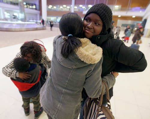 PHIL HOSSACK / WINNIPEG FREE PRESS -  Beaming relief, 16 yr old Naomi (right) is welcomed to Winnipeg by her sister Alice Thursday night. Long thought lost and dead when her mother and siblings fled Congo, she was recently found and is now reunited with her mother and siblings. Carol Sanders story. - March 8, 2018