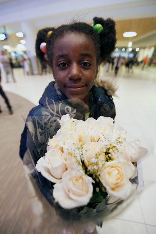 PHIL HOSSACK / WINNIPEG FREE PRESS -  9 yr old Rachael Bisimwa waits patiently holding a bouquet of white roses to welcome her sister Naomi (16) long thought dead, 16 yr old Naomi arrived in Winnipeg on a flight from Toronto with her mother Maria Thursday night to be reunited with Rachel and the rest of her siblings and a nephew she never knew. Carol Sanders story. - March 8, 2018