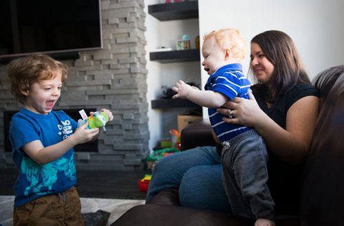 MIKAELA MACKENZIE / WINNIPEG FREE PRESS
Mom Jamie Streilein and her sons Keaton, three (left), and Elliot, nine months, at their home in Sage Creek in Winnipeg, Manitoba on Sunday, March 11, 2018. The Streilein family, as well as others in the subdivision, have little to no hope of getting their kids into the school in the area.
180311 - Sunday, March 11, 2018.