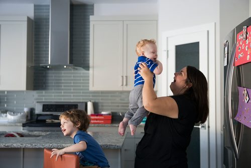 MIKAELA MACKENZIE / WINNIPEG FREE PRESS
Mom Jamie Streilein and her sons Keaton, three, and Elliot, nine months, at their home in Sage Creek in Winnipeg, Manitoba on Sunday, March 11, 2018. The Streilein family, as well as others in the subdivision, have little to no hope of getting their kids into the school in the area.
180311 - Sunday, March 11, 2018.