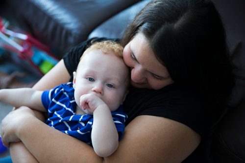 MIKAELA MACKENZIE / WINNIPEG FREE PRESS
Mom Jamie Streilein and her son Elliot, nine months, at their home in Sage Creek in Winnipeg, Manitoba on Sunday, March 11, 2018. The Streilein family, as well as others in the subdivision, have little to no hope of getting their kids into the school in the area.
180311 - Sunday, March 11, 2018.