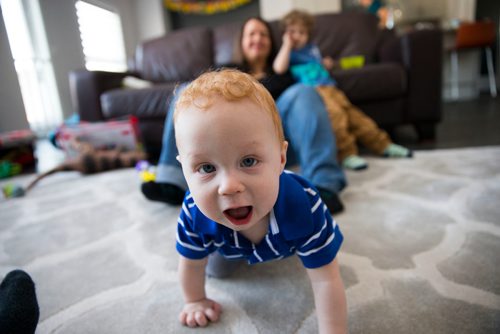 MIKAELA MACKENZIE / WINNIPEG FREE PRESS
Elliot Streilein, nine months, crawls up to the camera while posing for a family portrait at home in Sage Creek in Winnipeg, Manitoba on Sunday, March 11, 2018. The Streilein family, as well as others in the subdivision, have little to no hope of getting their kids into the school in the area.
180311 - Sunday, March 11, 2018.