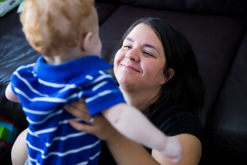 MIKAELA MACKENZIE / WINNIPEG FREE PRESS
Mom Jamie Streilein and her son Elliot, nine months, at their home in Sage Creek in Winnipeg, Manitoba on Sunday, March 11, 2018. The Streilein family, as well as others in the subdivision, have little to no hope of getting their kids into the school in the area.
180311 - Sunday, March 11, 2018.