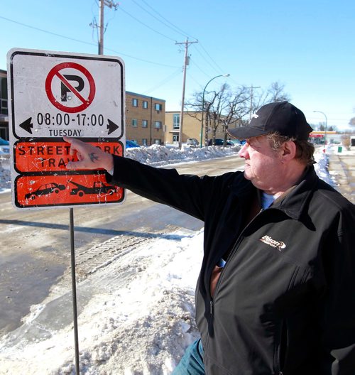 BORIS MINKEVICH / WINNIPEG FREE PRESS
Thomas Morfoot - standing next to sign he kept before city workers replaced them - is very unhappy because signage on Clayton Drive says road work will be done Tuesday between 8-5. When they saw it the Morfoots say they called 311 to confirm they wouldn't have to move their vehicle before then. Today their vehicle, along with every other vehicle on the street, plus all the vehicles on Bonita, were all towed.  RYAN THORPE STORY. March 12, 2018