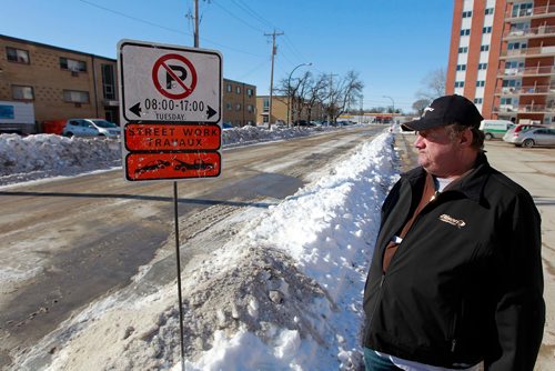 BORIS MINKEVICH / WINNIPEG FREE PRESS
Thomas Morfoot - standing next to sign he kept before city workers replaced them - is very unhappy because signage on Clayton Drive says road work will be done Tuesday between 8-5. When they saw it the Morfoots say they called 311 to confirm they wouldn't have to move their vehicle before then. Today their vehicle, along with every other vehicle on the street, plus all the vehicles on Bonita, were all towed.  RYAN THORPE STORY. March 12, 2018