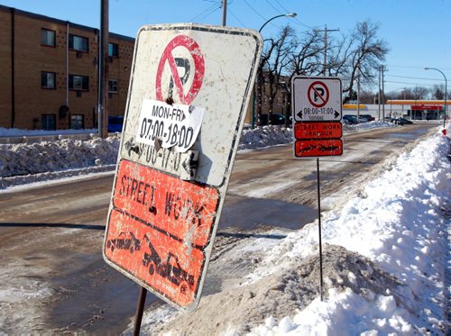 BORIS MINKEVICH / WINNIPEG FREE PRESS
Thomas Morfoot is very unhappy because signage on Clayton Drive says road work will be done Tuesday between 8-5. When they saw it the Morfoots say they called 311 to confirm they wouldn't have to move their vehicle before then. Today their vehicle, along with every other vehicle on the street, plus all the vehicles on Bonita, were all towed.  Morfoot kept one of the signs as city workers were removing and replacing them with corrected times - both shown here. RYAN THORPE STORY. March 12, 2018