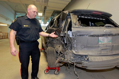 BORIS MINKEVICH / WINNIPEG FREE PRESS
Winnipeg police are telling drivers to be cautious after a three-vehicle collision Sunday afternoon involving a Police traffic SUV. The MVC happened at Fermor Ave. at Navin Rd on Sunday. Here traffic division Staff Sgt. Sean Pollock shows the the vehicle involved to the media inside police headquarters.  March 12, 2018