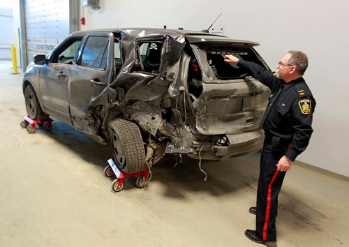 BORIS MINKEVICH / WINNIPEG FREE PRESS
Winnipeg police are telling drivers to be cautious after a three-vehicle collision Sunday afternoon involving a Police traffic SUV. The MVC happened at Fermor Ave. at Navin Rd on Sunday. Here Const. Rob Carver shows the the vehicle involved to the media inside police headquarters.  March 12, 2018