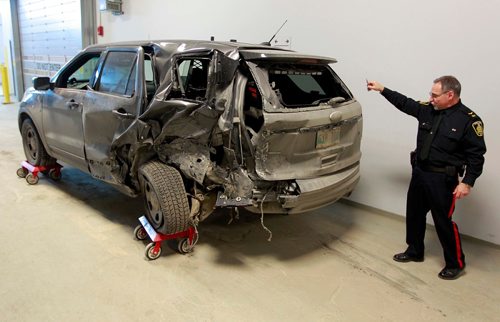 BORIS MINKEVICH / WINNIPEG FREE PRESS
Winnipeg police are telling drivers to be cautious after a three-vehicle collision Sunday afternoon involving a Police traffic SUV. The MVC happened at Fermor Ave. at Navin Rd on Sunday. Here Const. Rob Carver shows the the vehicle involved to the media inside police headquarters.  March 12, 2018