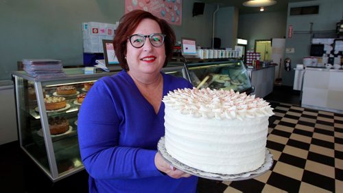 BORIS MINKEVICH / WINNIPEG FREE PRESS
For This City piece toasting Baked Expectation's 35th anniversary. Business is at 161 Osborne St.
Beth Grubert is the owner of Baked Expectations. Here she holds a large cake that they sell. March 14, 2018