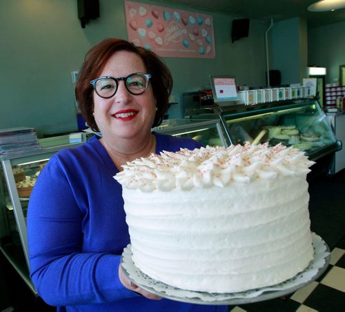 BORIS MINKEVICH / WINNIPEG FREE PRESS
For This City piece toasting Baked Expectation's 35th anniversary. Business is at 161 Osborne St.
Beth Grubert is the owner of Baked Expectations. Here she holds a large cake that they sell. March 14, 2018