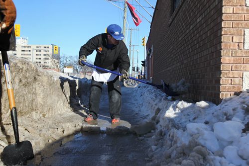 RUTH BONNEVILLE / WINNIPEG FREE PRESS

Workers from a restaurant at 878 Ellice Ave. clear snow and ice from the sidewalk in front of their entranceway Tuesday.  

See story on snow clearing.  

March 14 ,2018