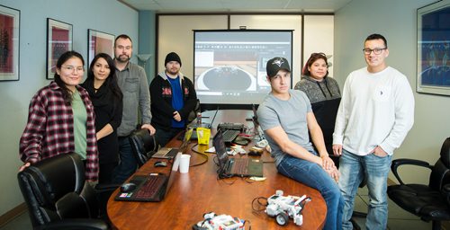 MIKAELA MACKENZIE / WINNIPEG FREE PRESS
Robotics instructors Lisa Harper (left), Alexis Nelson, Chris Schulz, Kane Slavuta, Shini Barratt, Tia Dumas, and Jared Bone at the First Peoples Development Inc. offices in Winnipeg on Thursday, March 15, 2018. First Peoples Development Inc. has teamed up with a Winnipeg robotics company called Cogmation to deliver two-week long robotics coding workshops in First Nations in Manitoba that culminate in a Lego robot Sumo wrestling competition.
 Mikaela MacKenzie / Winnipeg Free Press 15, 2018.