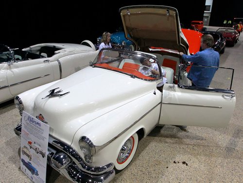 BORIS MINKEVICH / WINNIPEG FREE PRESS
World of Wheels gets set up at the RBC Convention Centre today. From left, Doris Brunotte, Ron Sweeney, Pat Fletcher get a 1953 Oldsmobile Fiesta convertible, one of only 4 left in the world. It's part of the world renowned Crossroads Oil Collection based in Winnipeg. The show runs through the weekend. STANDUP PHOTO. March 15, 2018