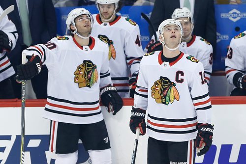 Chicago Blackhawks' Jonathan Toews (19) and Brandon Saad (20) watch the replay of Saad's challenged goal against the Winnipeg Jets during the first period NHL action in Winnipeg on Thursday, March 15, 2018. THE CANADIAN PRESS/John Woods