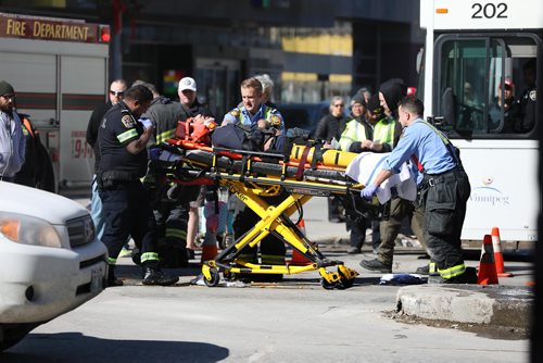RUTH BONNEVILLE  /  WINNIPEG FREE PRESS

A man is taken away on a stretcher after being struck by a vehicle in the westbound lane of Portage Ave. at Donald Street Saturday afternoon.  Traffic was closed in the westbound lane for a time but two lanes next to the curb lane are now open.  


March 17, 2018