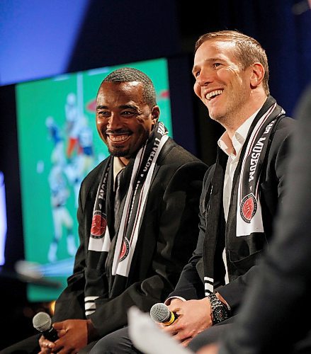 PHIL HOSSACK / WINNIPEG FREE PRESS -Barron Miles (left) and Brent Johnson share a laugh watching replays of their action of the football field Wednesday at the Investor's Group Field as they are announced to the CFL Hall of Fame. See story. - March 21, 2018