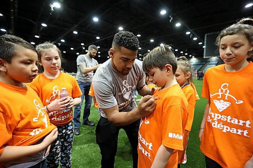 RUTH BONNEVILLE  /  WINNIPEG FREE PRESS

Andrew Harris, running back for the Winnipeg Blue Bombers, signs his autograph for students of Greenway School during break in skills sessions at the RBC Convention Centre Thursday.  Over 160 local Jumpstart kids aged 9-12 years old from Greenway School and Victory School participated in football skills training led by 10 current CFL players.

Standup photo 


March 22,  2018
