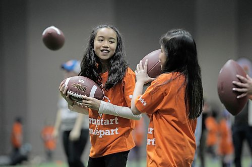 RUTH BONNEVILLE  /  WINNIPEG FREE PRESS

Mayumi Tolentine (left) and her friend Althea Medina Greenway School learn to throw a football duringskills sessions at the RBC Convention Centre Thursday.  Over 160 local Jumpstart kids aged 9-12 years old from Greenway School and Victory School participated in football skills training led by 10 current CFL players.

Standup photo 


March 22,  2018