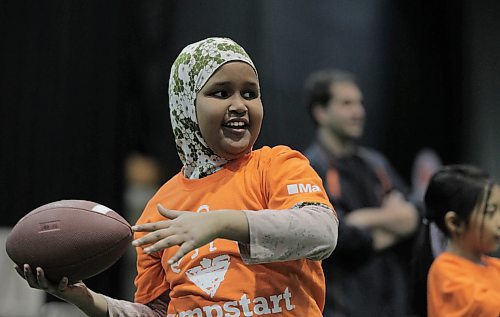 RUTH BONNEVILLE  /  WINNIPEG FREE PRESS

Shankaron Muse of Greenway School learns to throw a football during skills sessions at the RBC Convention Centre Thursday.  Over 160 local Jumpstart kids aged 9-12 years old from Greenway School and Victory School participated in football skills training led by 10 current CFL players.

Standup photo 


March 22,  2018